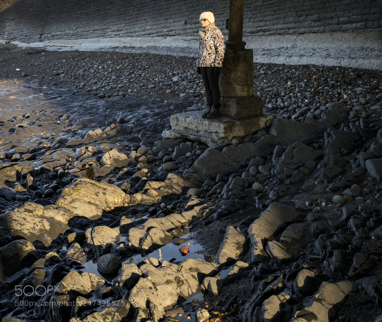 Sony a7R II sample photo. A woman staning underneath photography