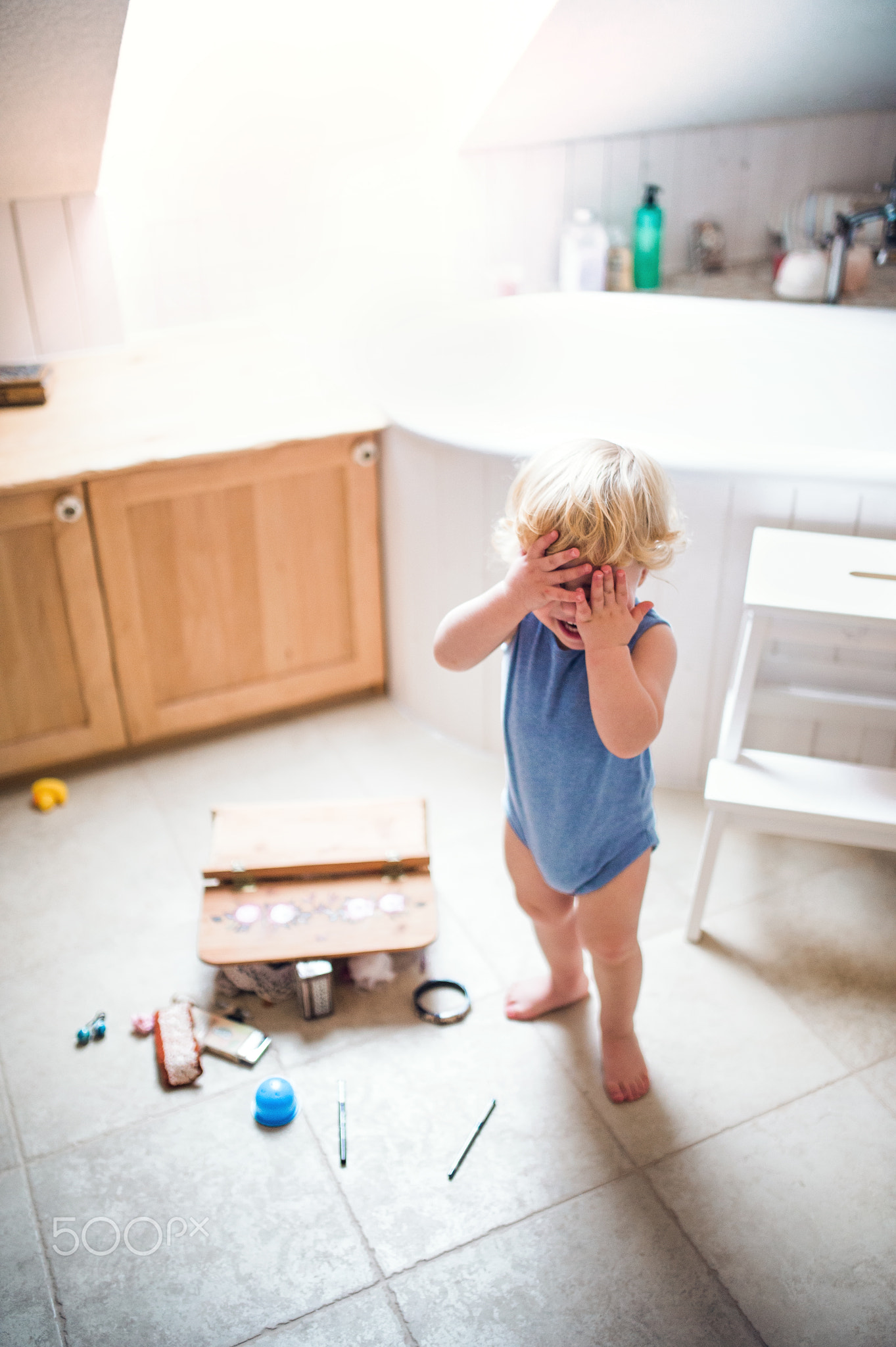 Toddler boy in a dangerous situation in the bathroom.