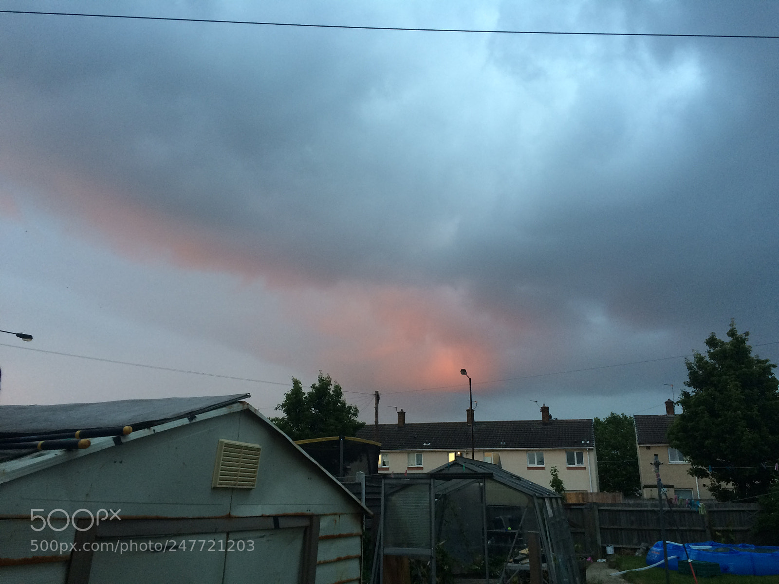 Apple iPhone 5s sample photo. Moody sky over houses photography