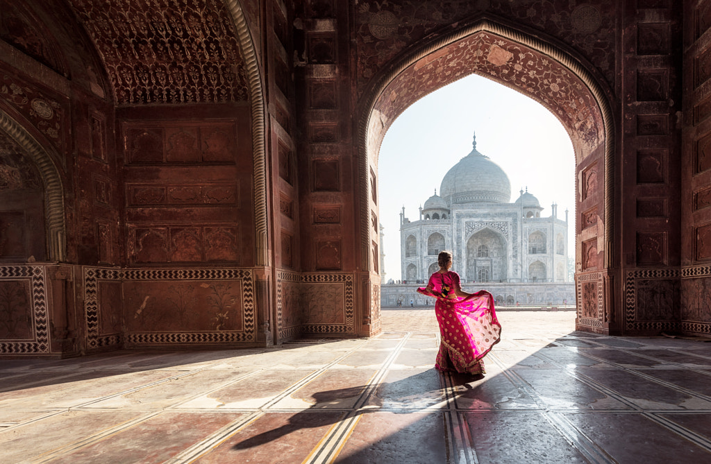 Woman in red saree/sari near the Taj Mahal by Sasin Tipchai on 500px.com