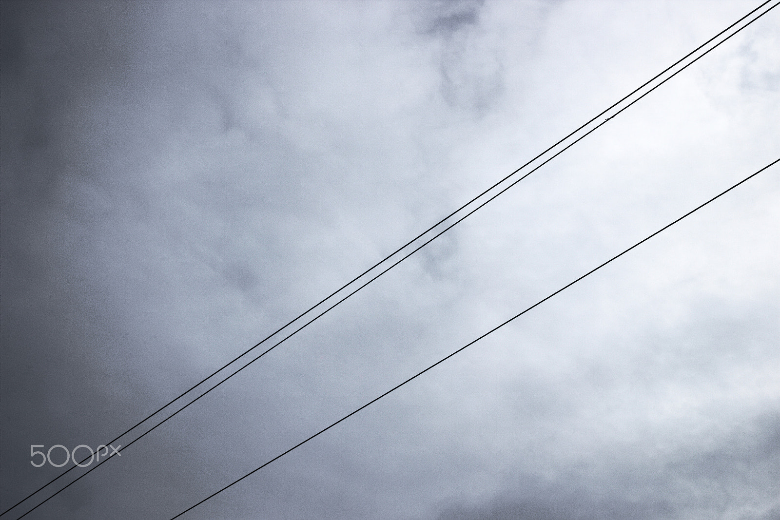 Canon EOS M10 sample photo. Wires against the heavy sky photography