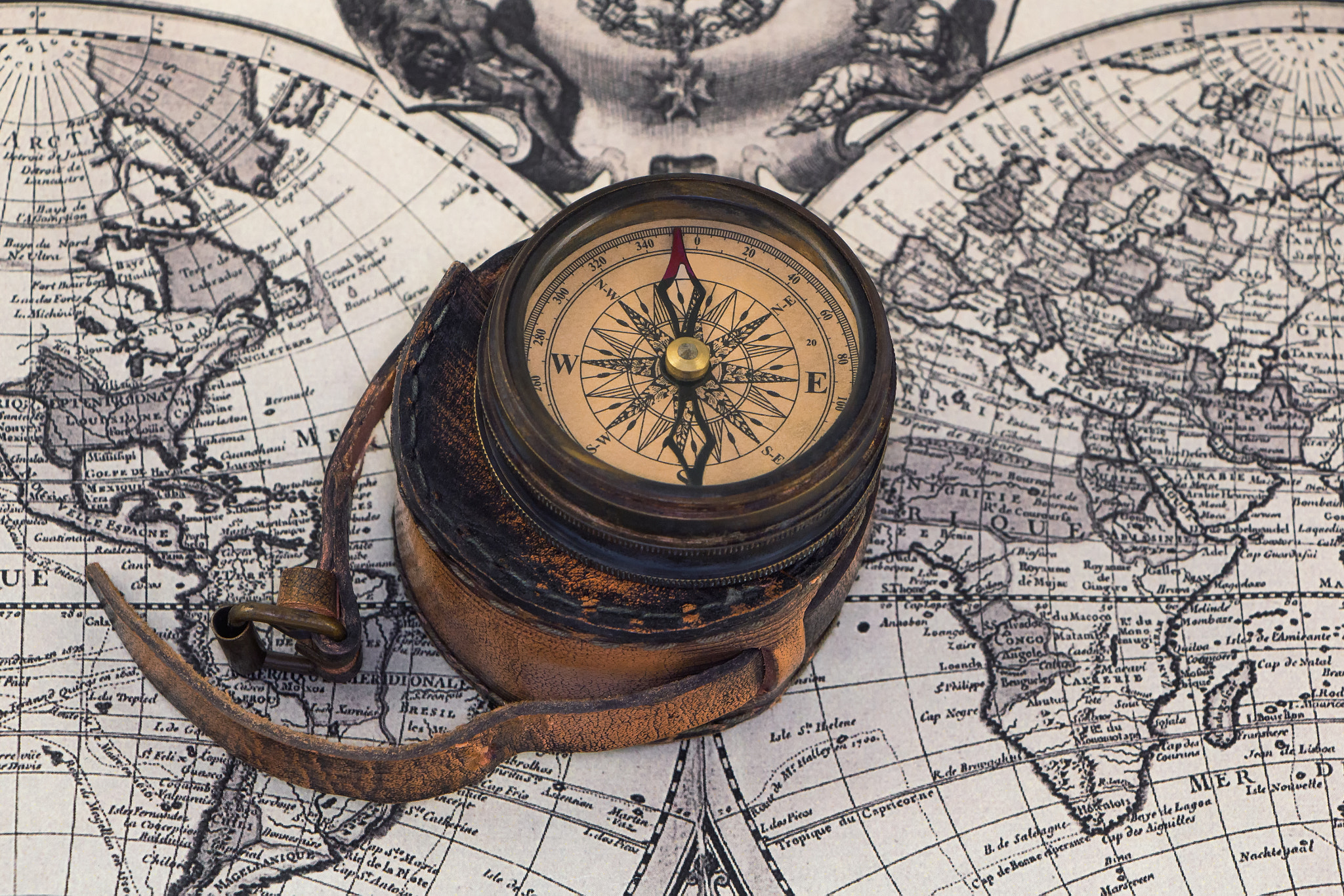 Ancient compass on the world map.