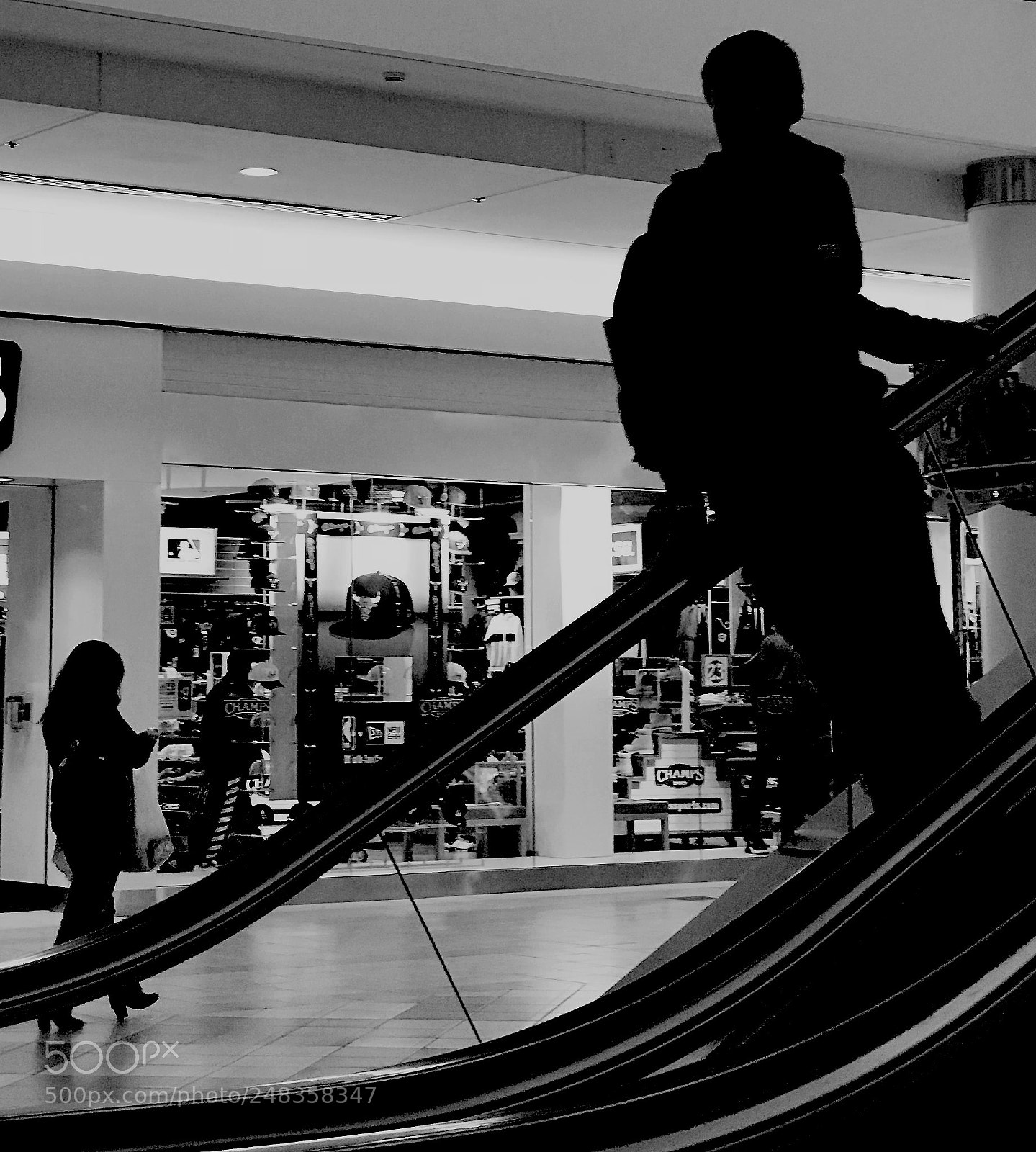 Apple iPhone 7 Plus sample photo. Teenager down the escalator photography