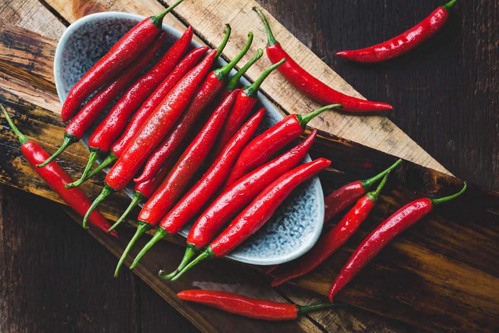 Red chillis on the old wood by Thai Thu on 500px.com