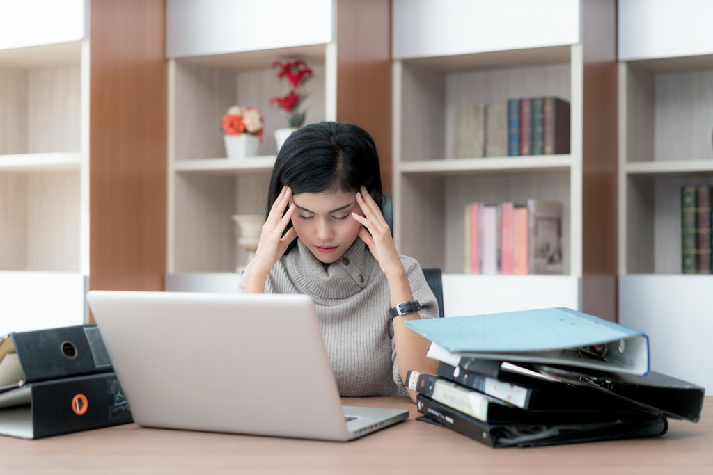 Portrait of tired young Asian business woman feeling stress from by Prasit Rodphan on 500px.com