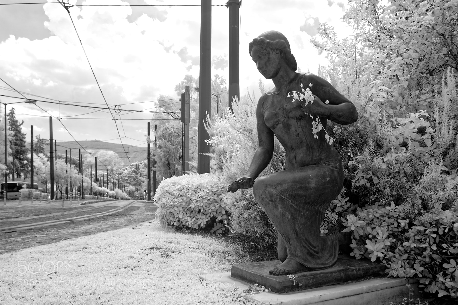 Sony Alpha NEX-5 sample photo. Statue holding flowers in photography