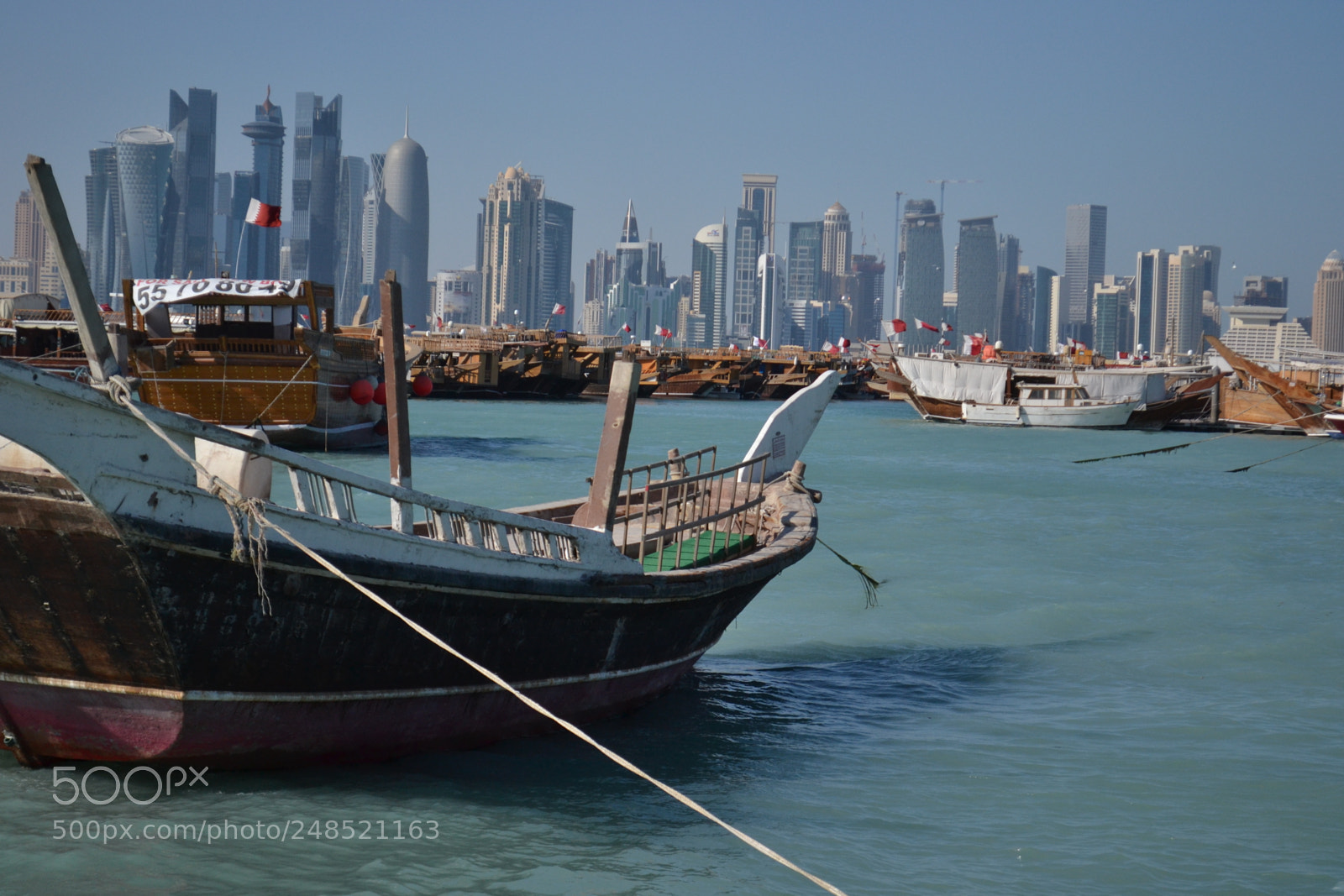 Nikon D3100 sample photo. Anchored boat with skyline photography