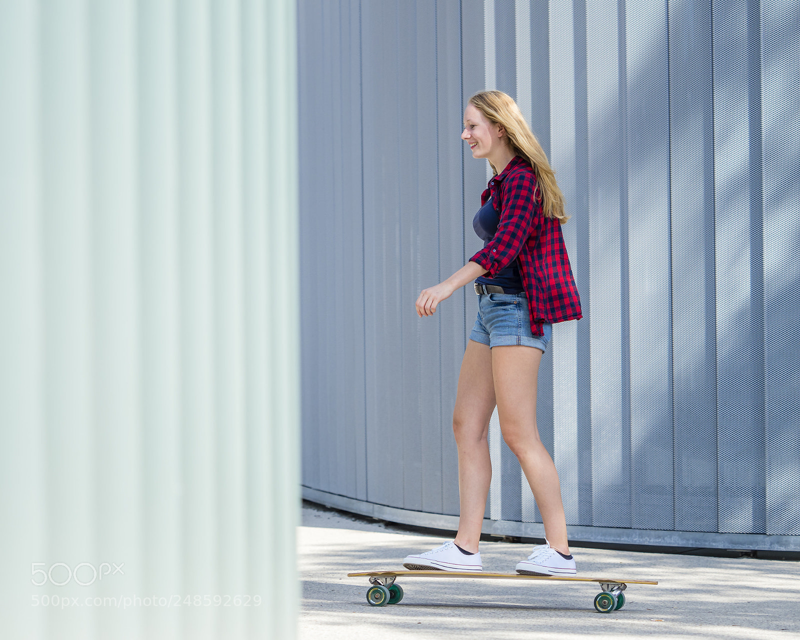 Olympus OM-D E-M1 Mark II sample photo. Young woman with longboard photography