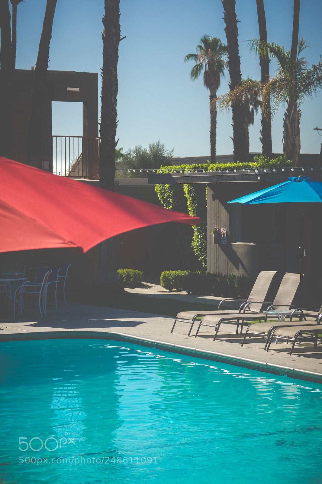 Sony Cyber-shot DSC-RX10 III sample photo. Motel pool with red photography