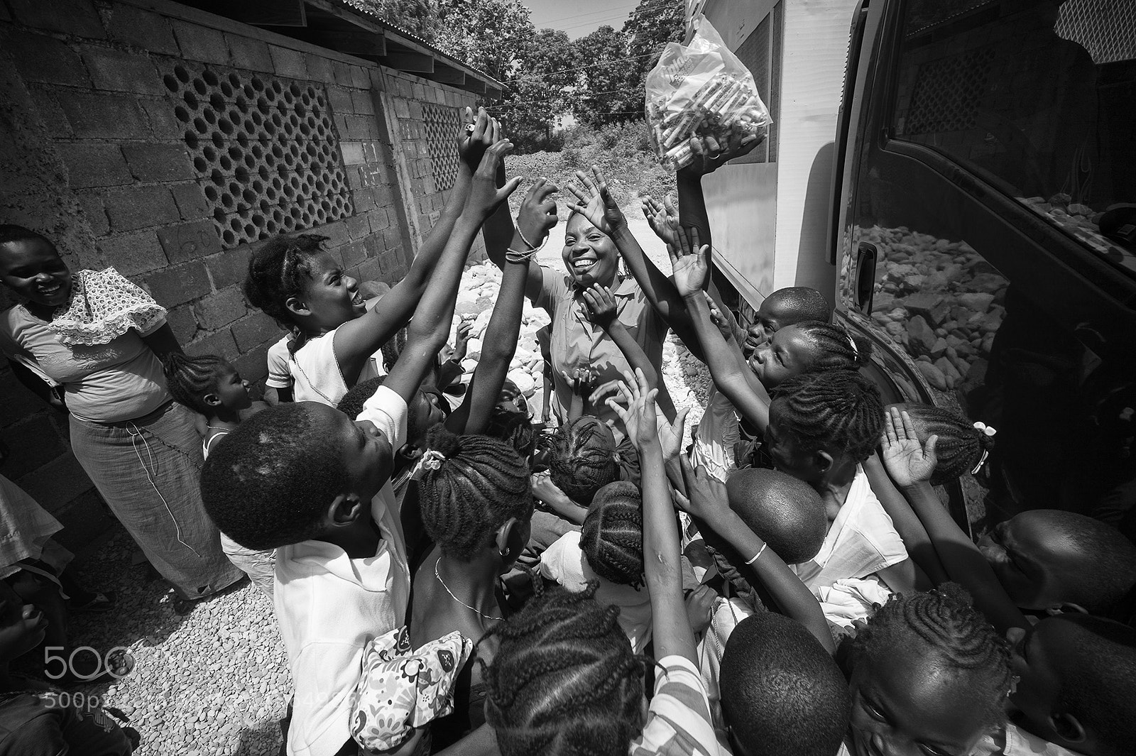 Leica M9 sample photo. Giving out candy, haiti photography
