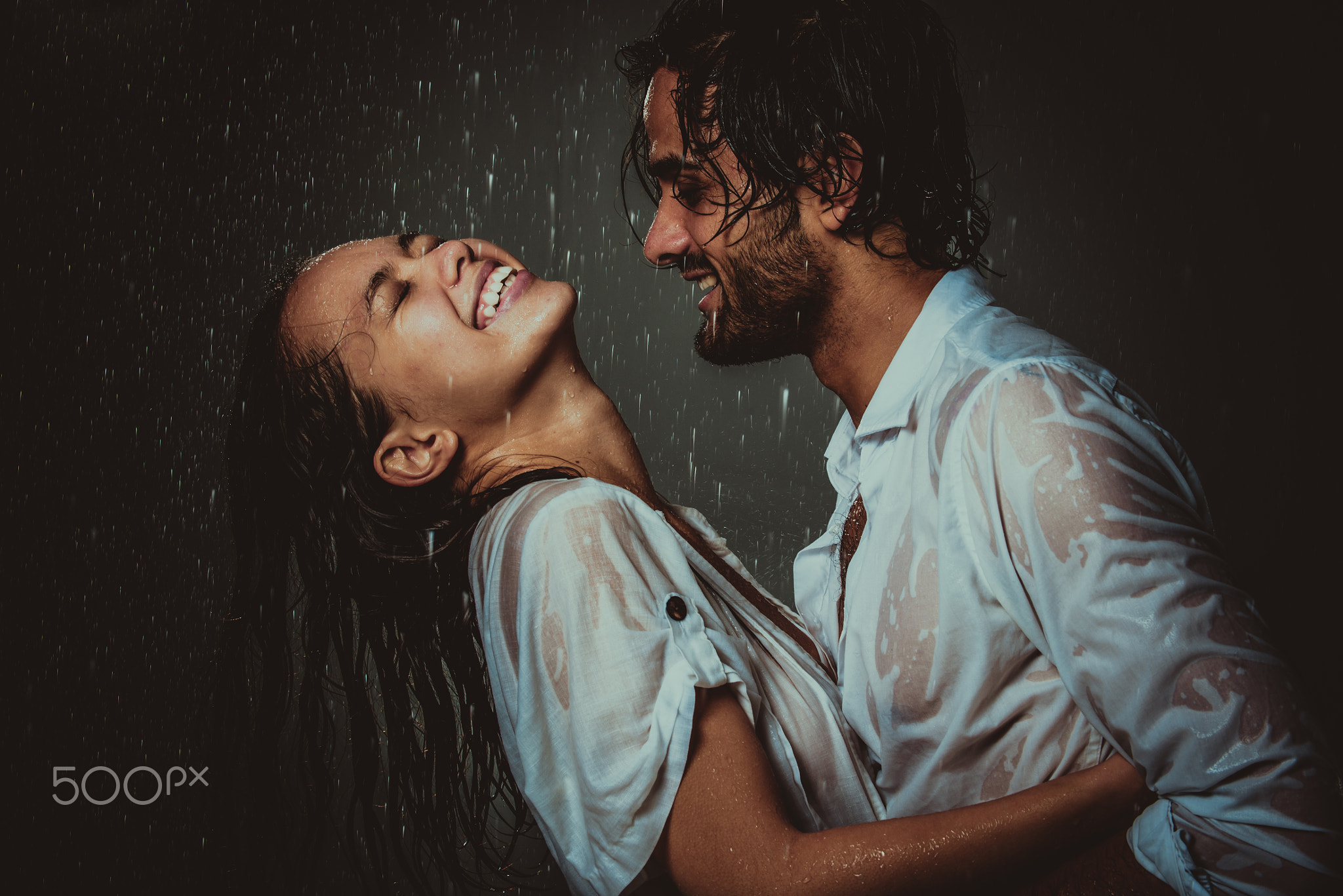 Couple sharing romantic moments under the rain