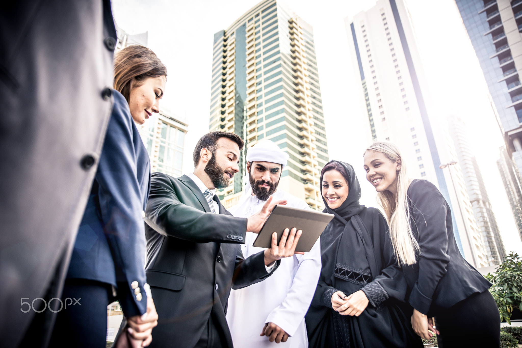 Arabic and western business people speaking about investments