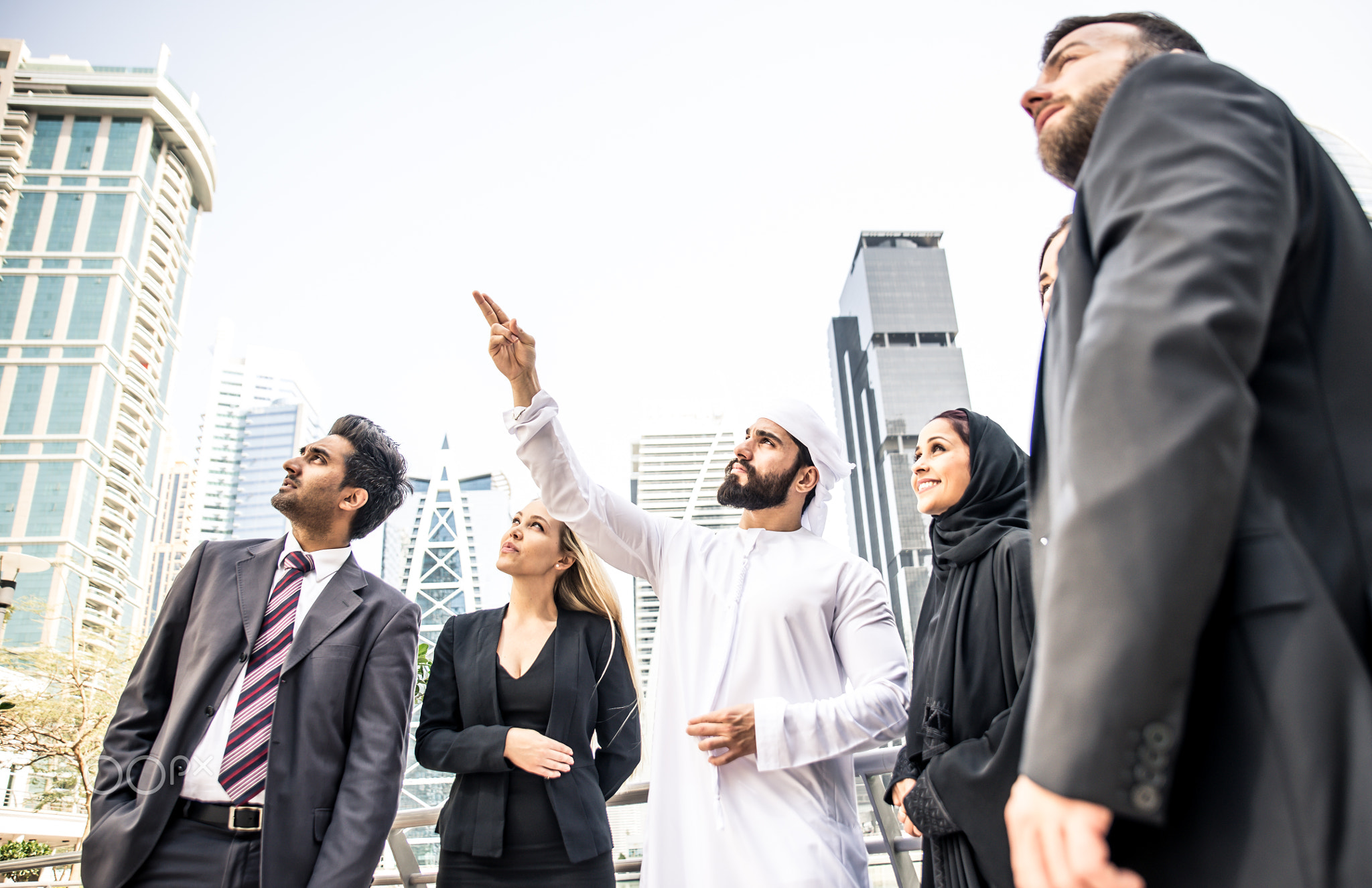 Arabic and western business people speaking about investments