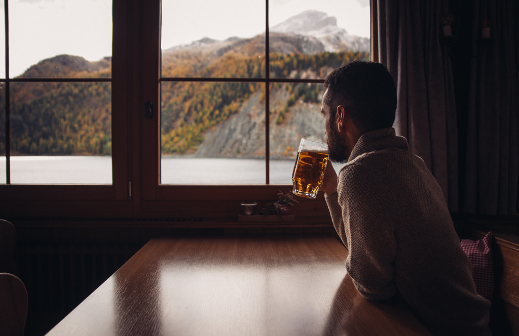 Man drinking beer in his mountain cabin by Cristian Negroni on 500px.com
