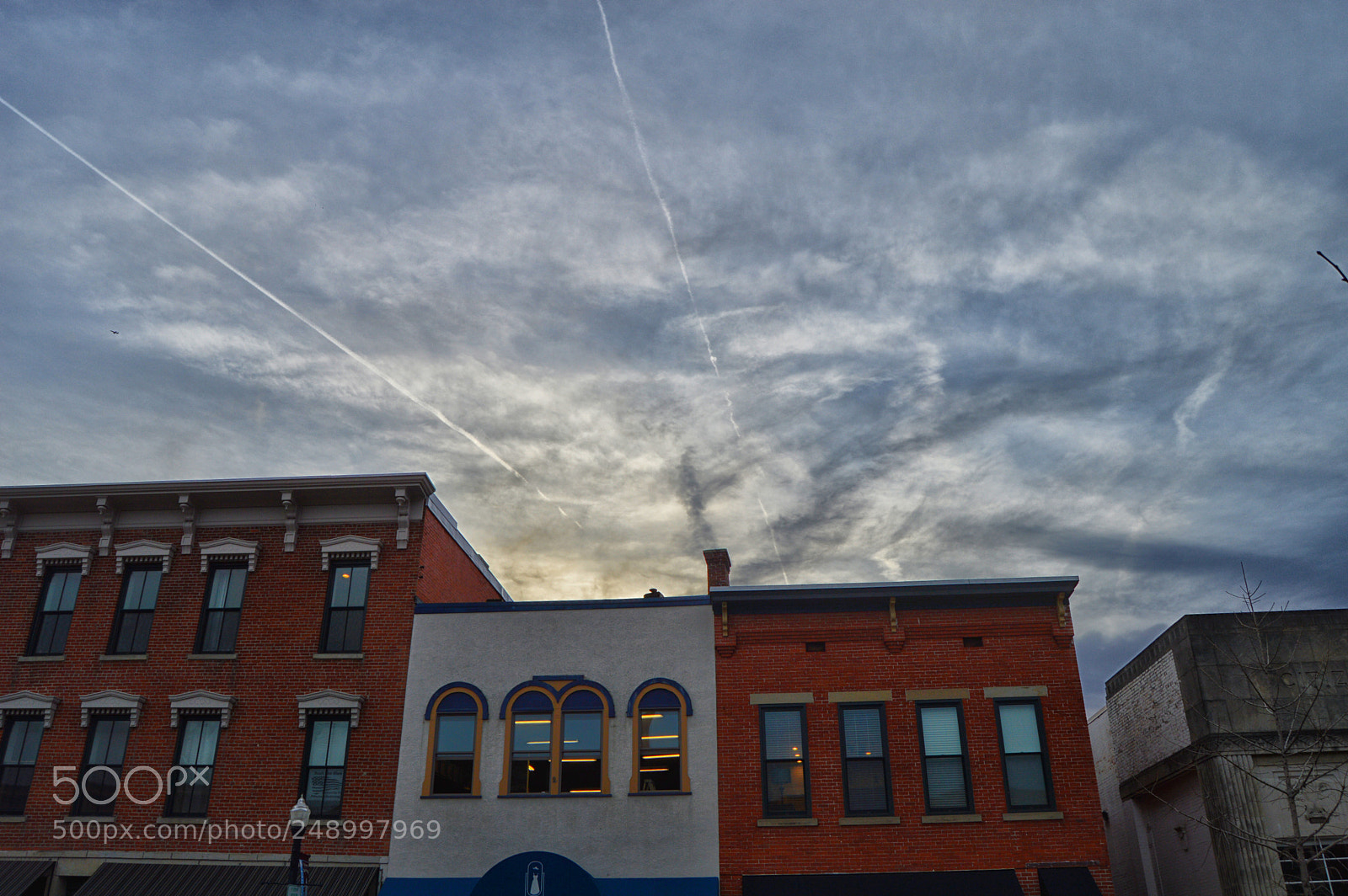Nikon D3200 sample photo. Clouds contrails buildings photography
