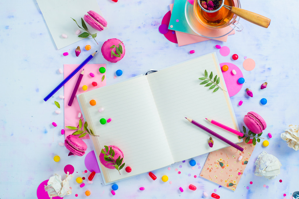 Colorful flat lay with an open book with blank pages, confetti, sweets, hard candy, pink... by Dina (Food Photography) on 500px.com