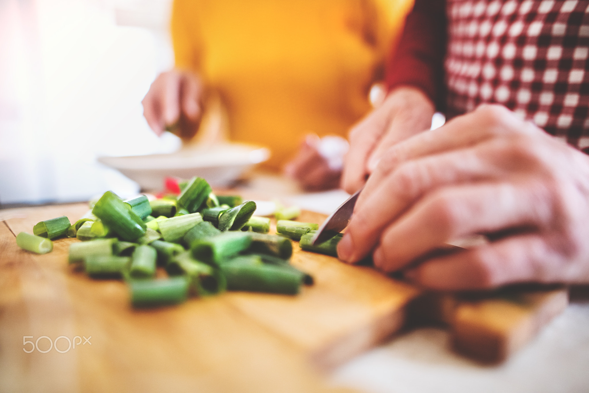 A senior man and woman preparing food in the kitchen.