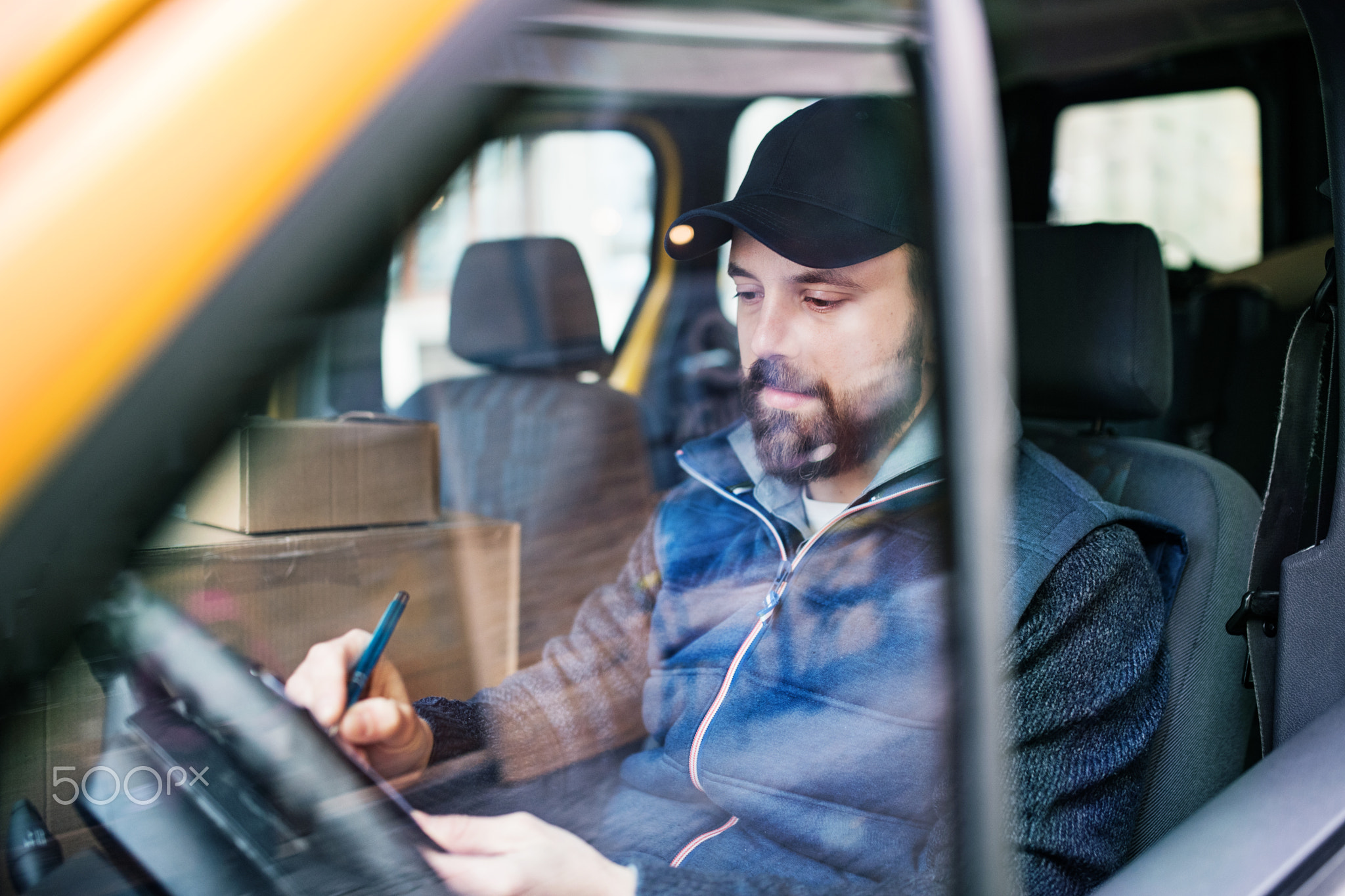 Delivery man delivering parcel box to recipient.