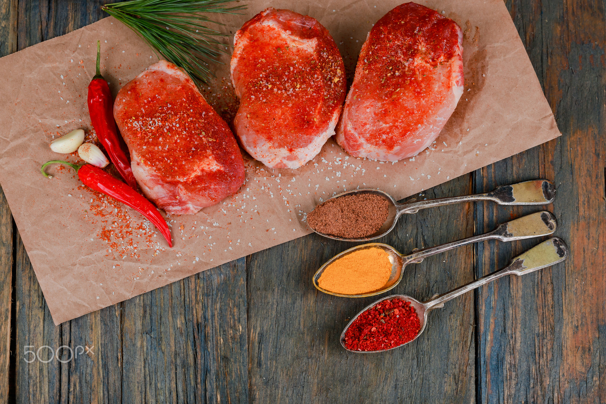 fresh raw beef steak on wooden cutting board, top view