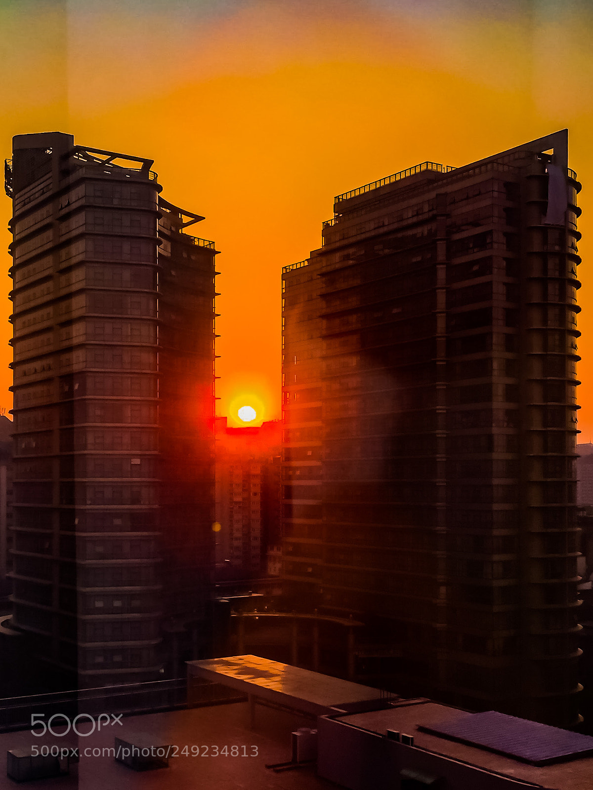 Apple iPhone 6 Plus sample photo. Sunrise between buildings photography