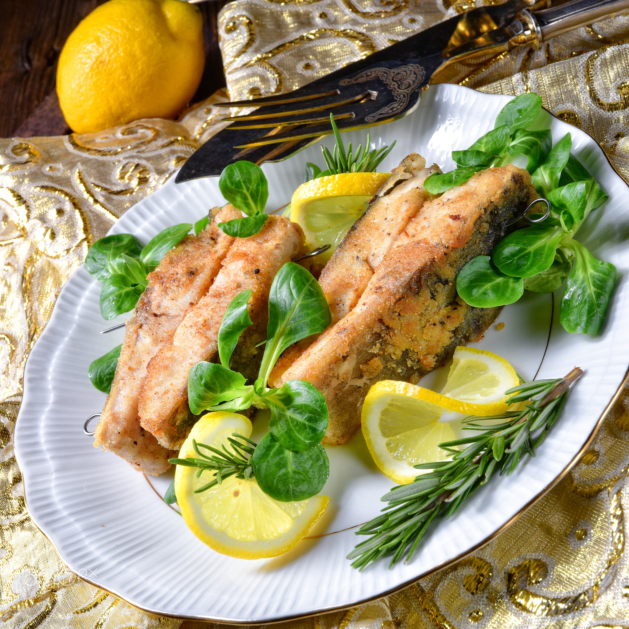 Fried carp fillet on wintry salad