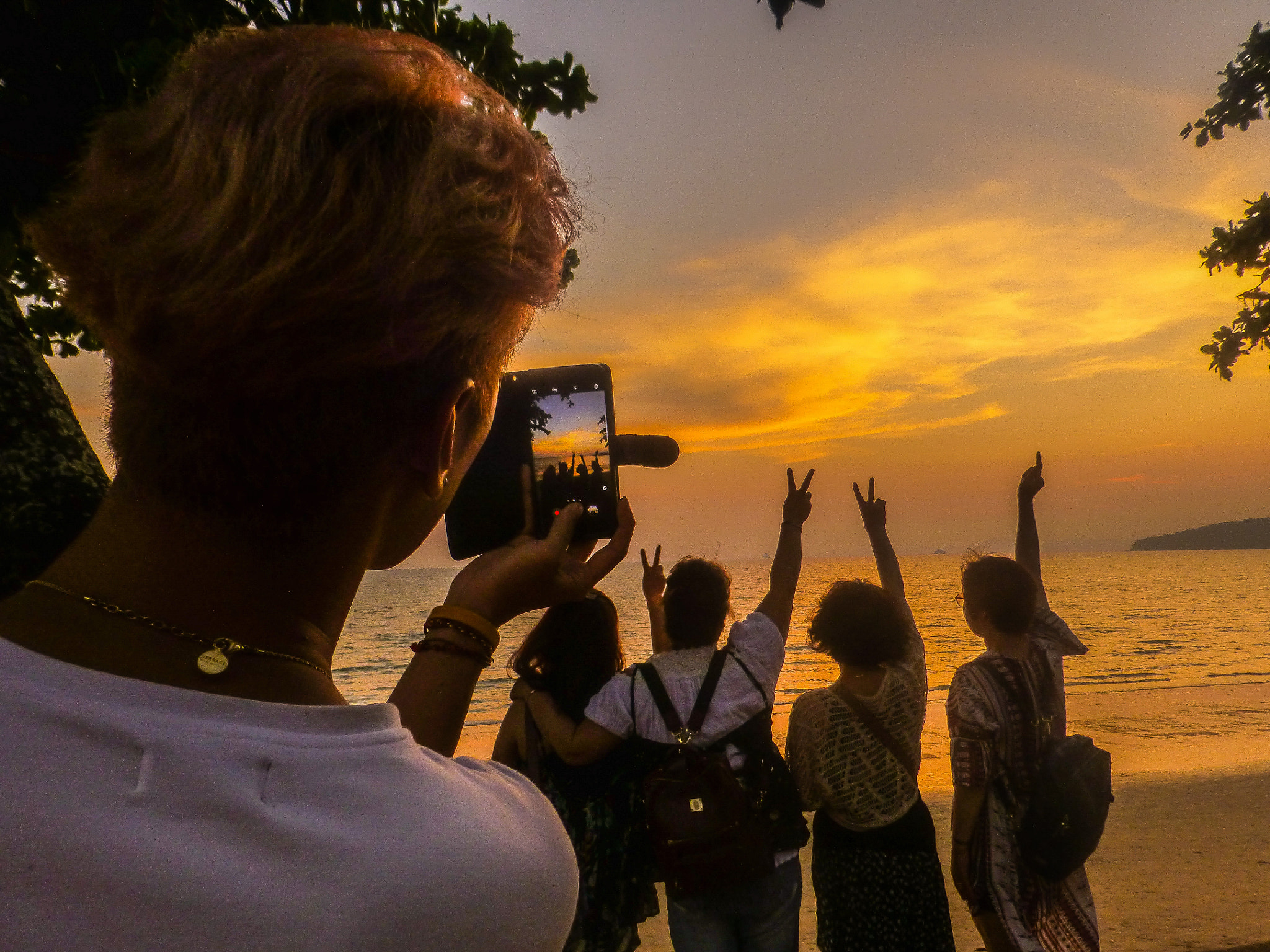 Panasonic Lumix DMC-ZS20 (Lumix DMC-TZ30) sample photo. Taking a photo of a person taking a photo of friends at sunset photography