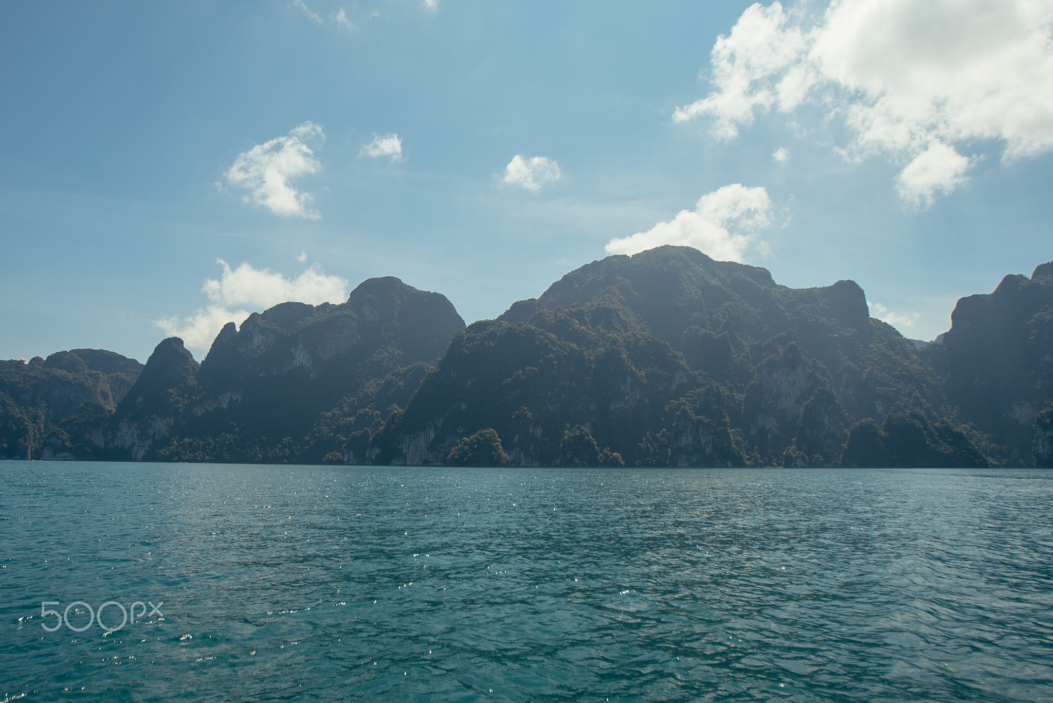 Tropical Thai jungle lake Cheo lan, wild mountains nature national park ship yacht rocks