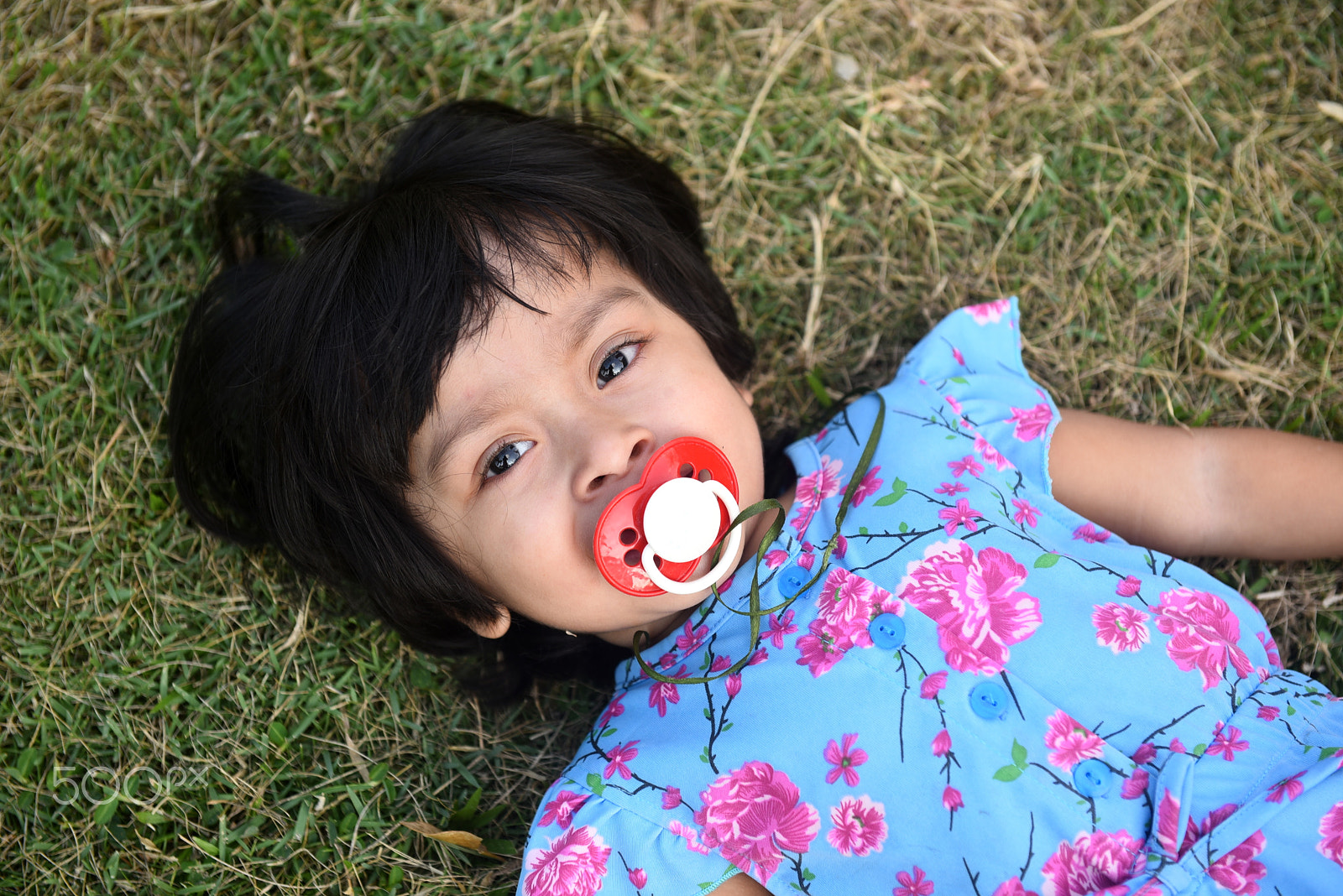 Nikon AF-S Nikkor 24-70mm F2.8G ED sample photo. Portrait cute little girl with her pacifier lying photography