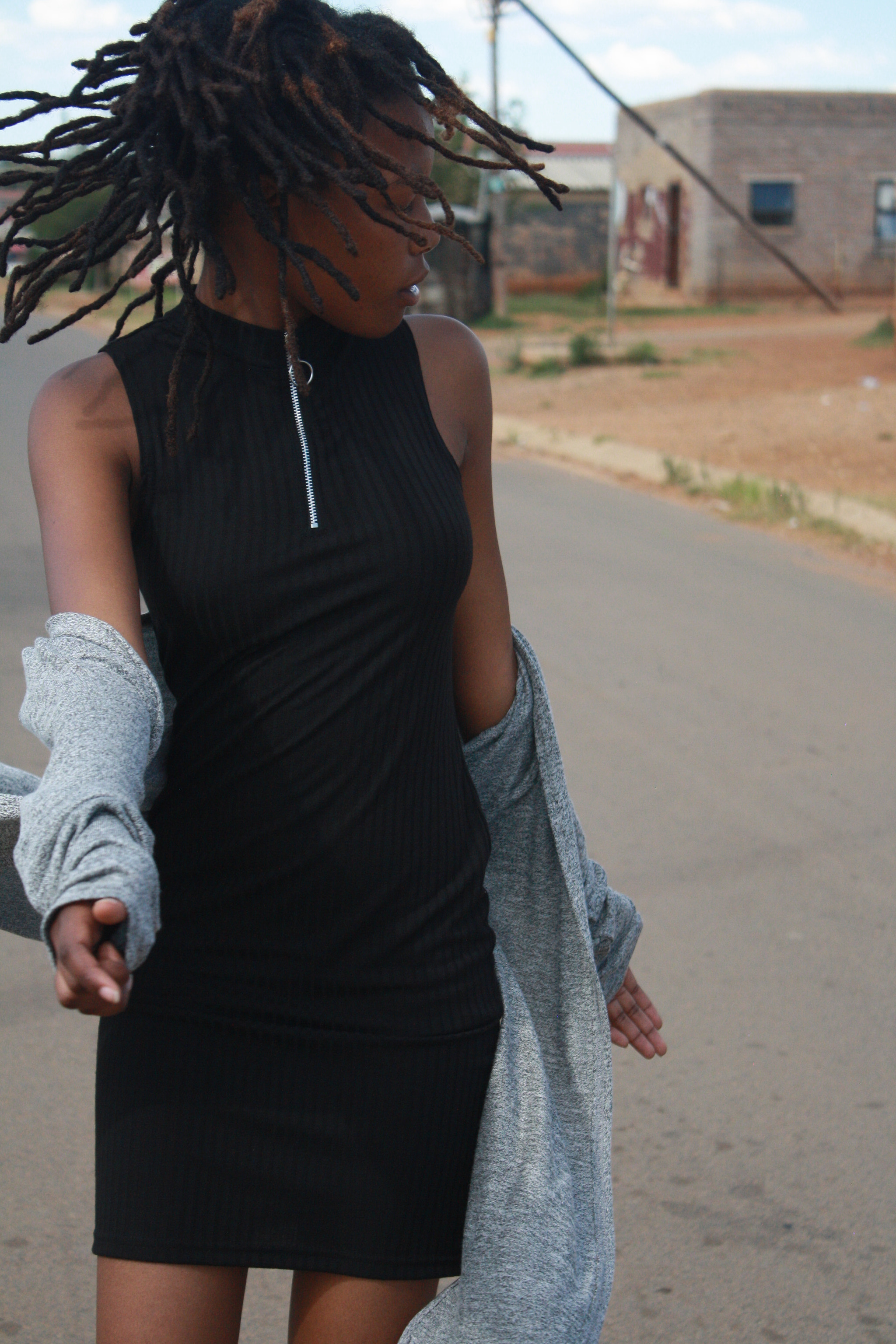 Canon EOS 1000D (EOS Digital Rebel XS / EOS Kiss F) sample photo. Girl with dreadlocks walking freely along the road photography