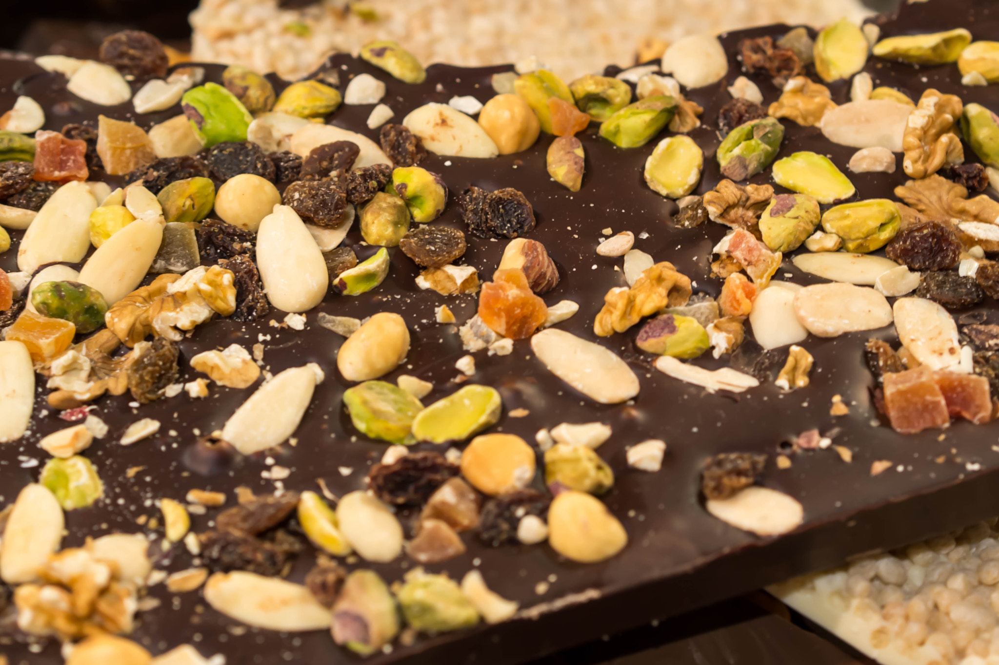 Olympus PEN E-PM2 sample photo. Dark chocolate with nuts and dried fruits photography