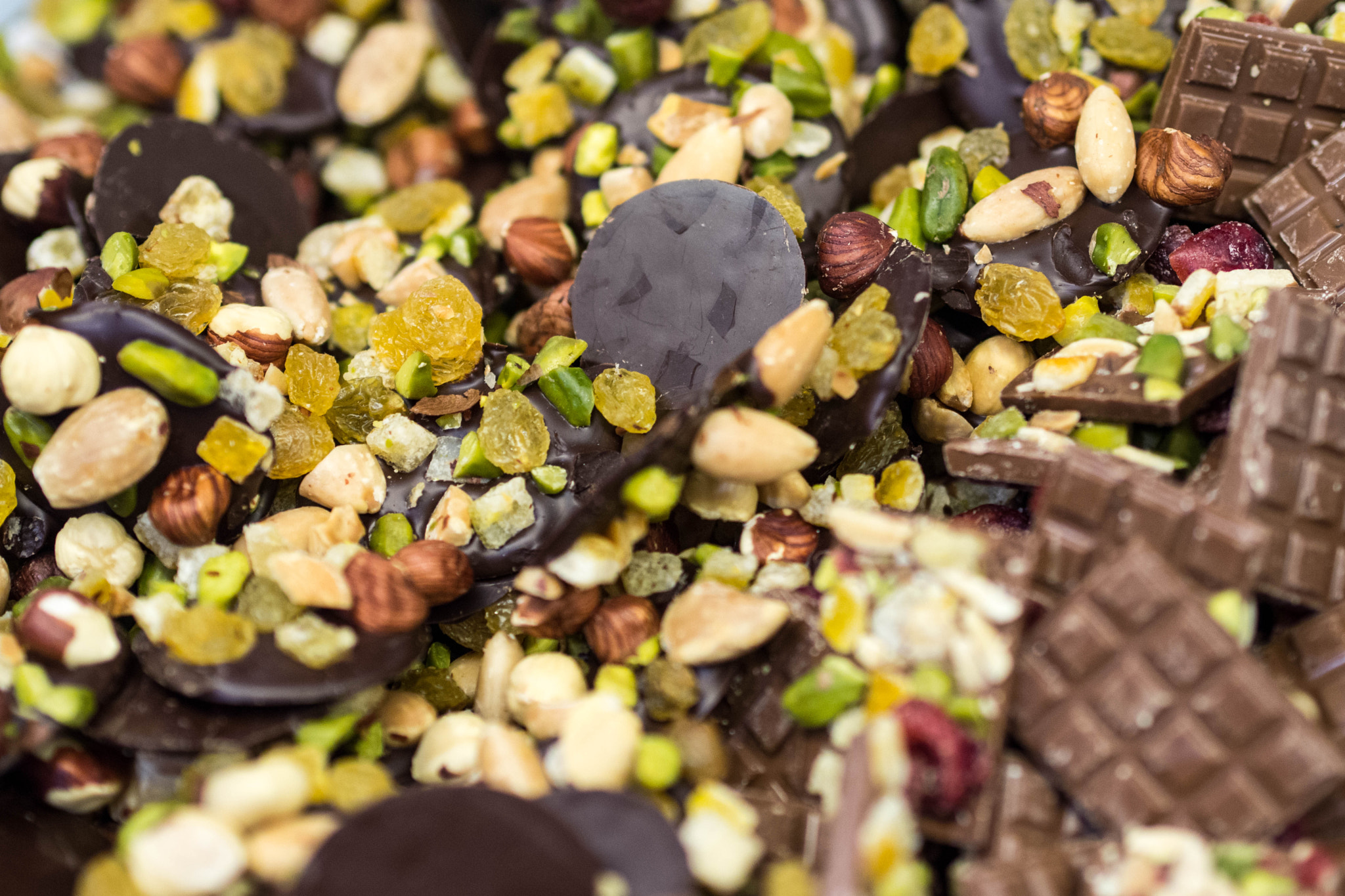 Olympus PEN E-PM2 sample photo. Chocolate with dried fruits and peanuts photography