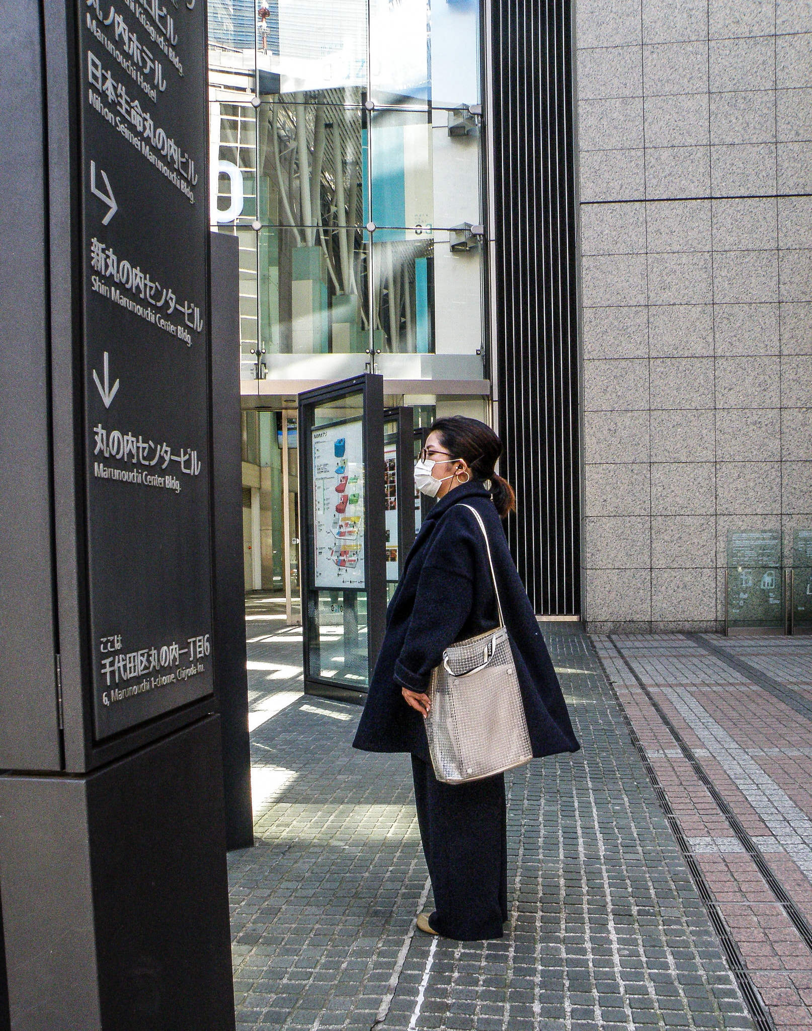 Olympus SP570UZ sample photo. A woman standing holding a bag. photography