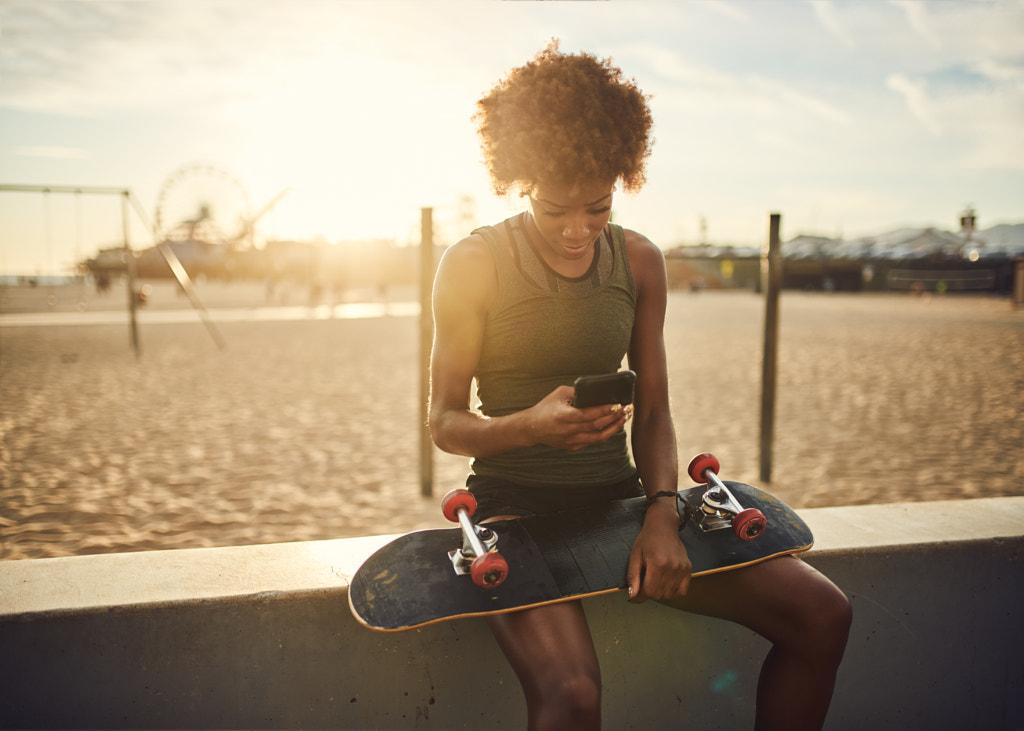 fit african american skater sitting down to look a by Joshua Resnick on 500px.com