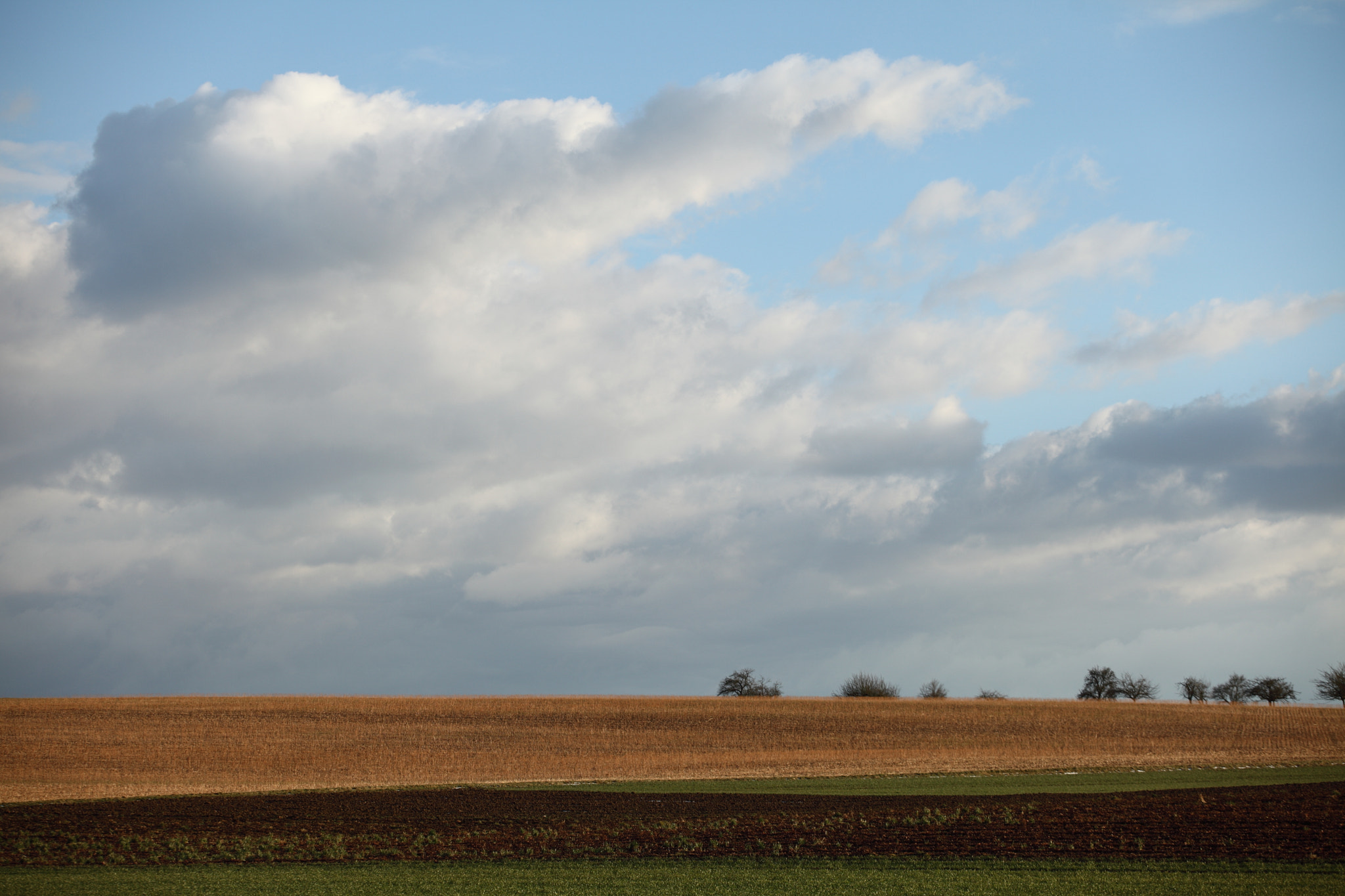 Canon EF 70-200mm F4L USM sample photo. Clouds ower the farmland photography
