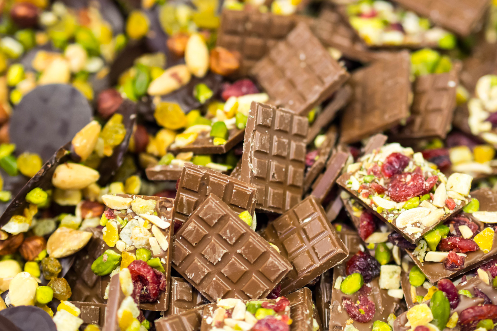 Olympus PEN E-PM2 sample photo. Chocolate with dried fruits and peanuts photography