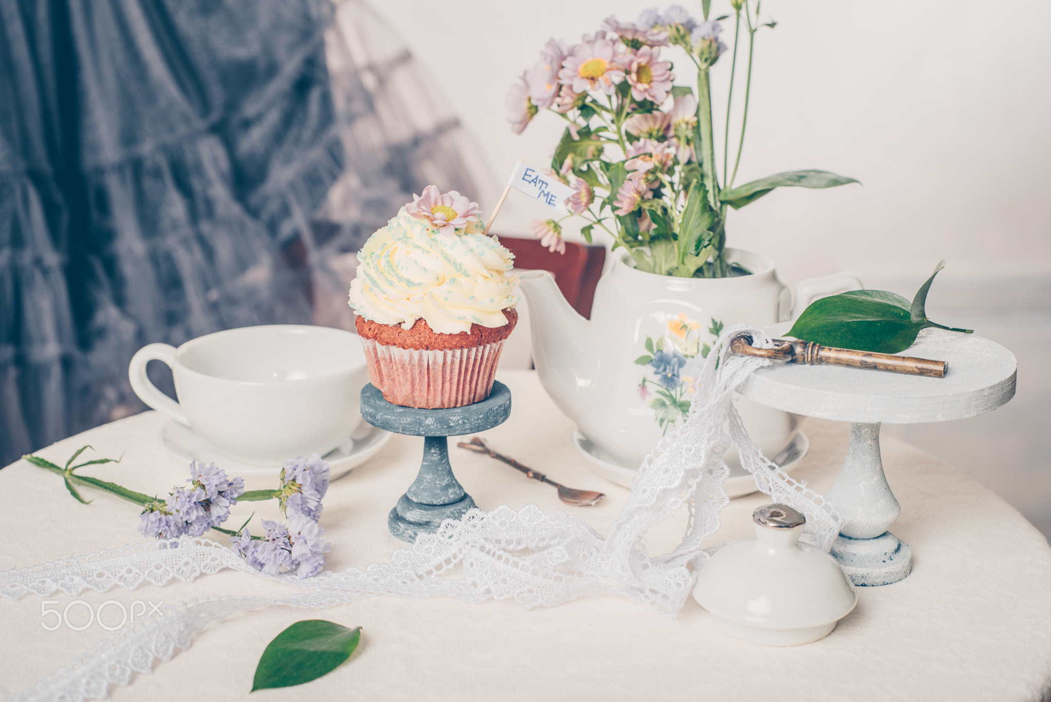 Cup cakes with cream cheese topping on beautiful wooden cake sta