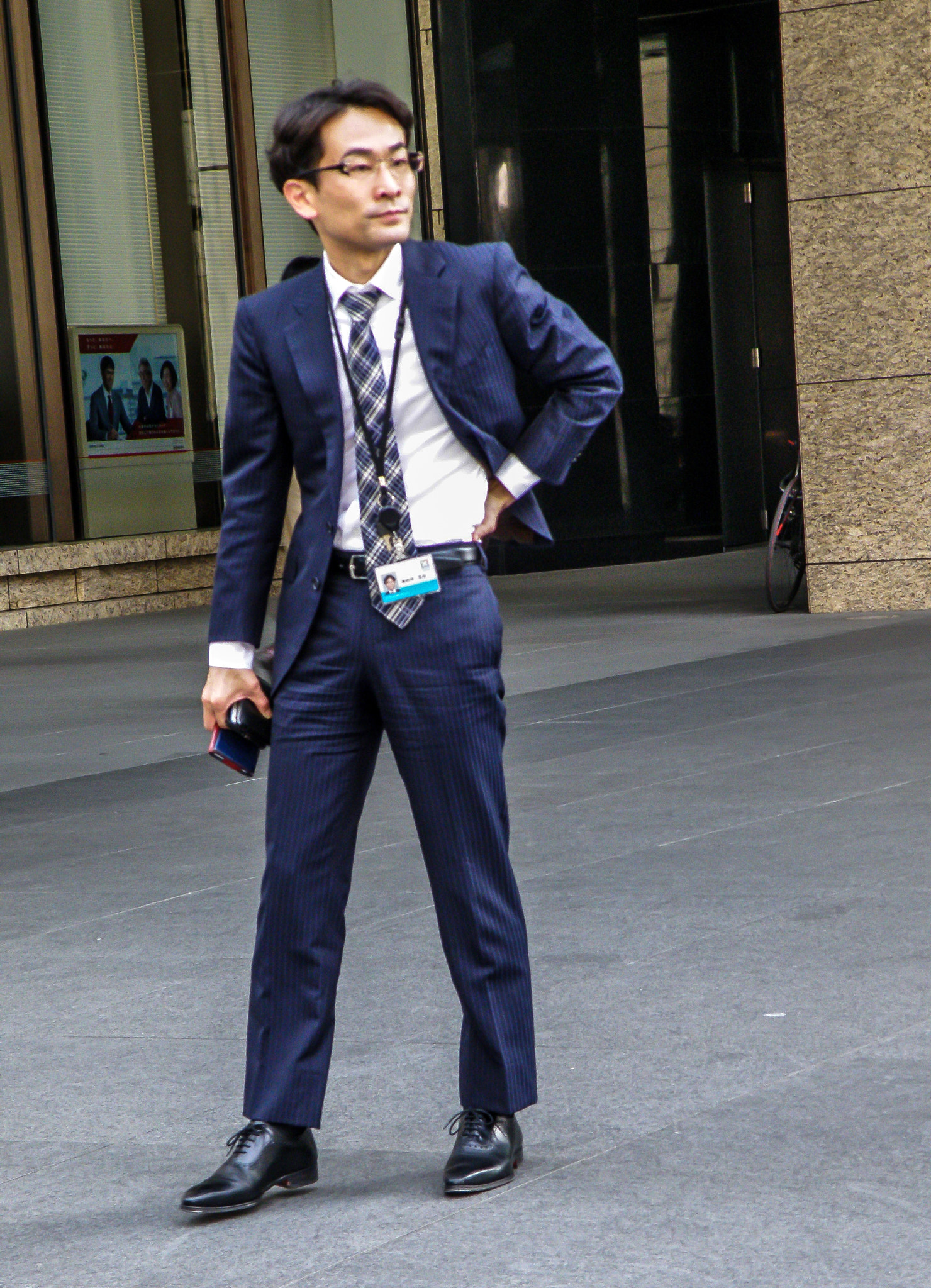 Olympus SP570UZ sample photo. A businessman going through the city photography