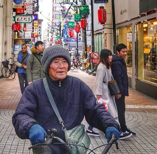 Sony a9 sample photo. Senior cycling thru town photography