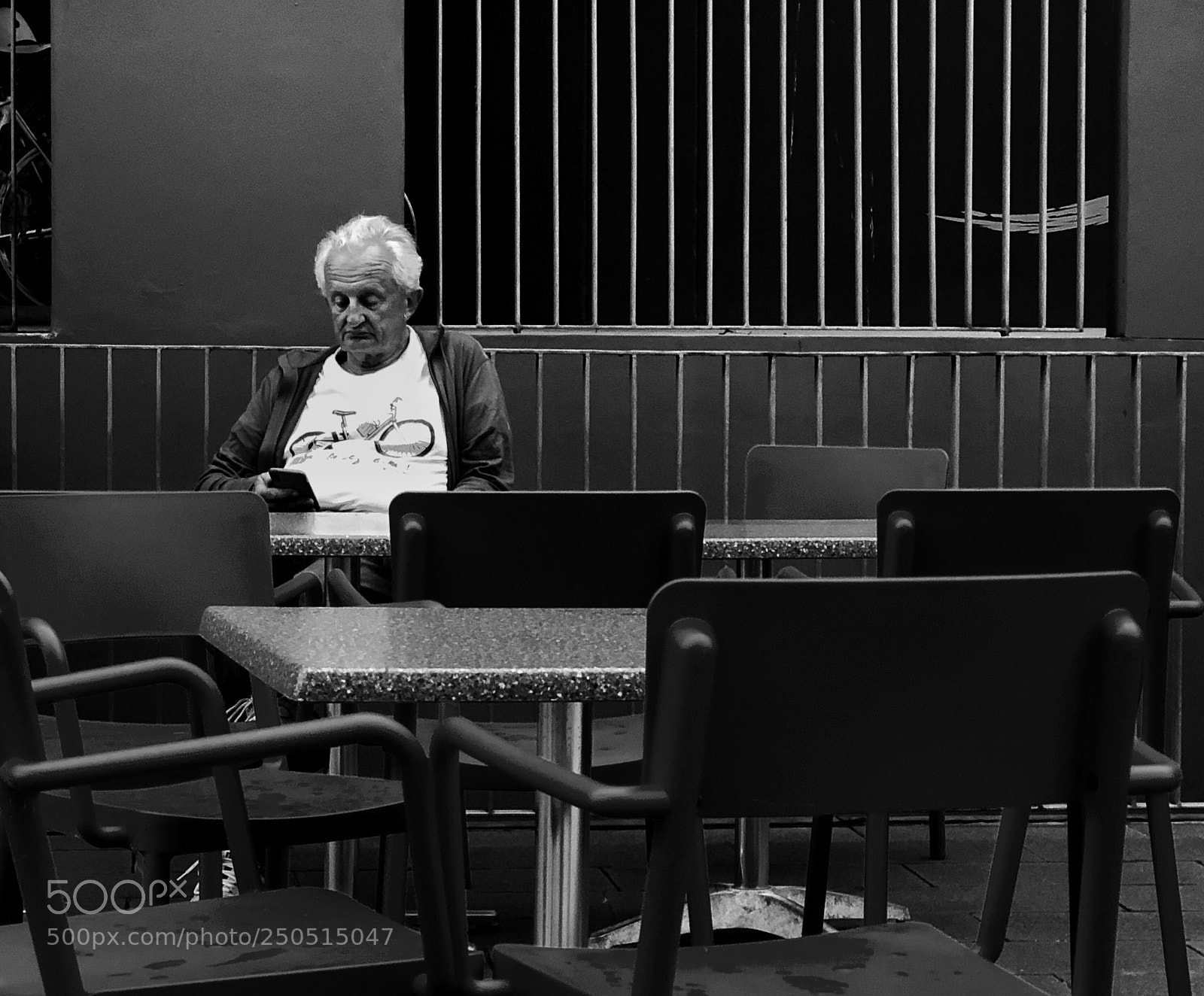 Apple iPhone X sample photo. Man and chairs photography
