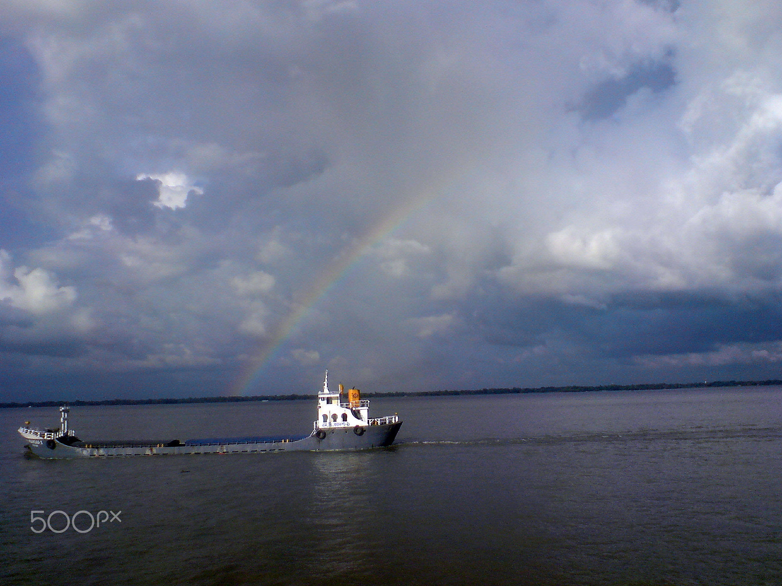 Sony Ericsson K850i sample photo. Rainbow over cargo in river, cloudy sky photography