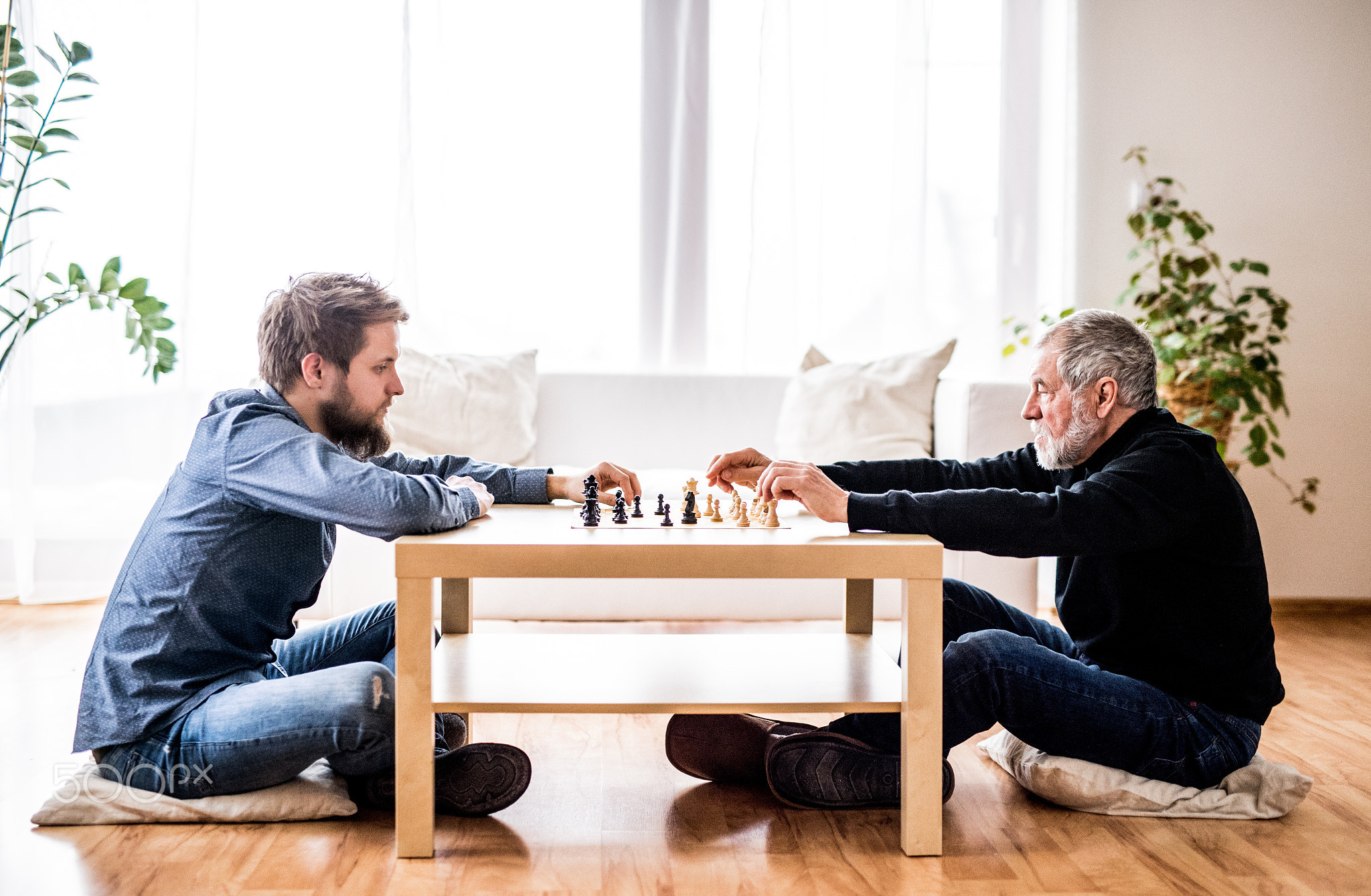 Hipster son and his senior father at home.