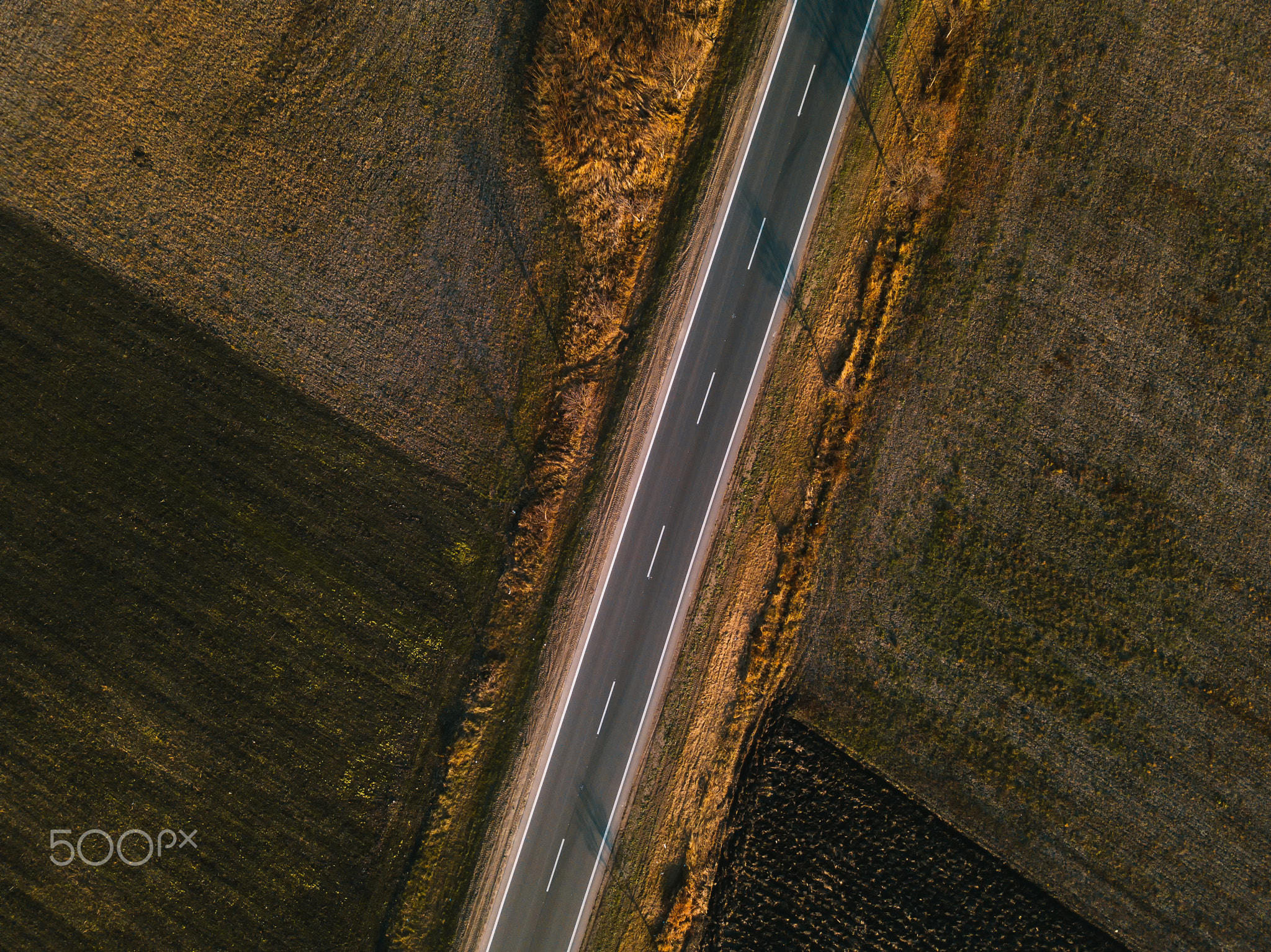 Aerial view of empty road through countryside
