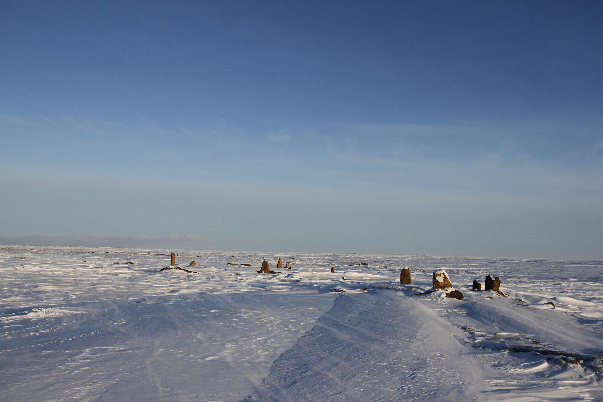Canon EF-S 10-22mm F3.5-4.5 USM sample photo. Standing stones found along an arctic landscape with snow on the ground photography