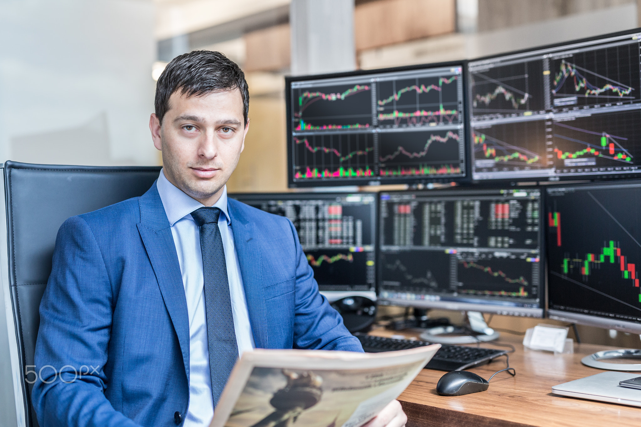 Business portrait of stock broker in traiding office.