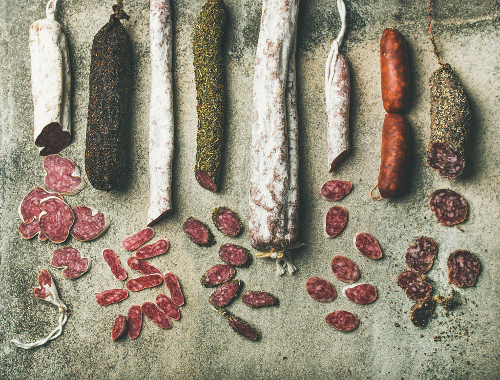 Variety of Spanish or Italian cured sausages cut in slices by Anna Ivanova on 500px.com
