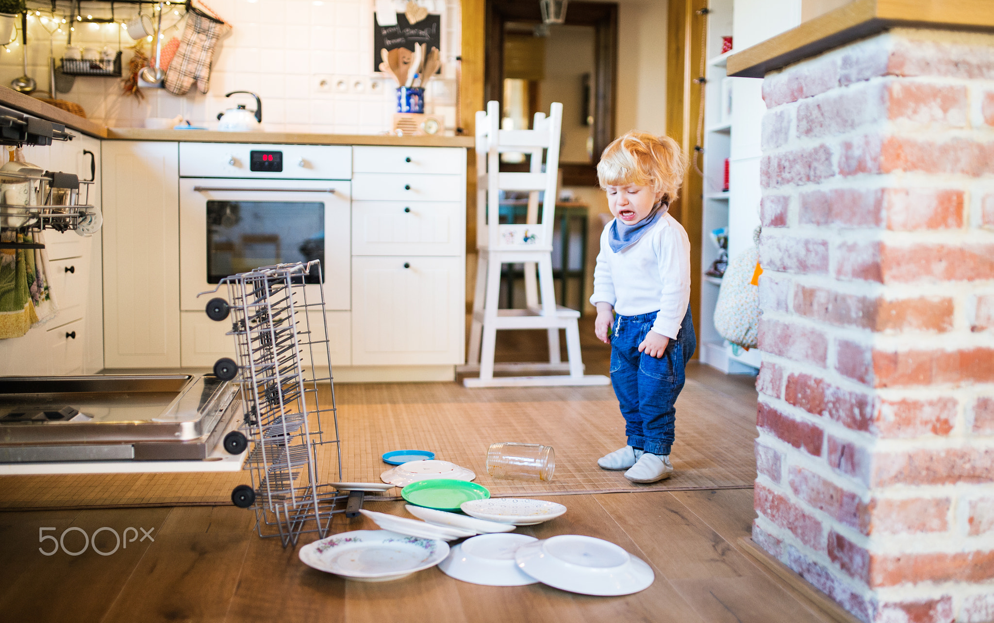 Toddler boy in dangerous situation at home. Child safety concept.