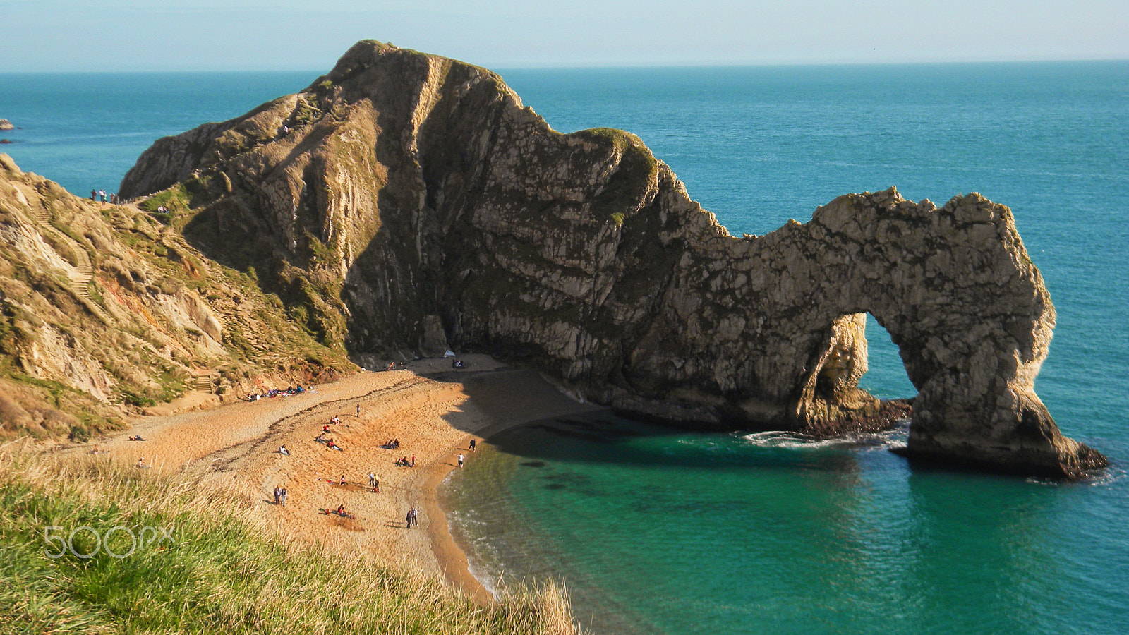 Nikon Coolpix L100 sample photo. British beach and cliffs with emerald water photography