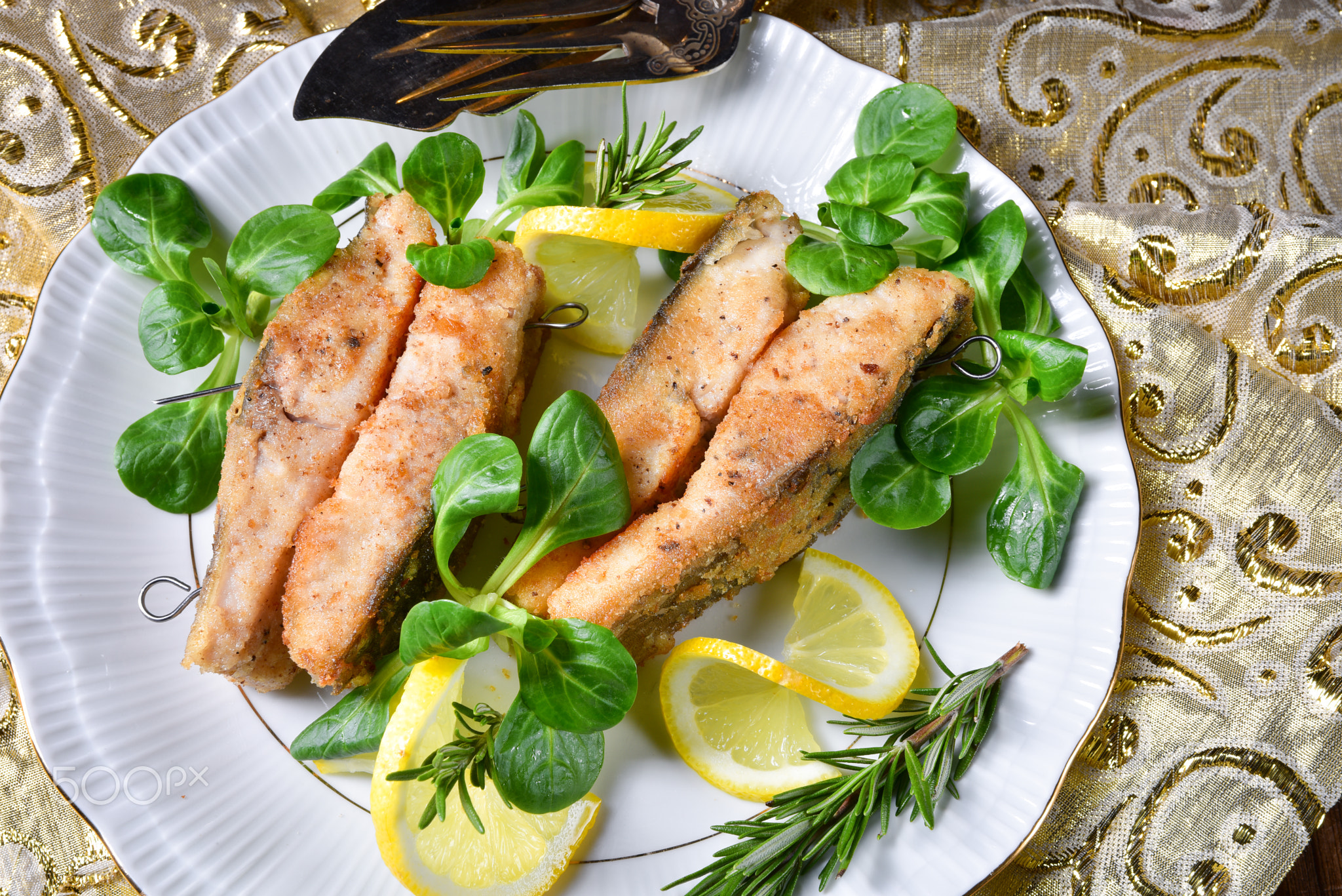 Fried carp fillet on wintry salad