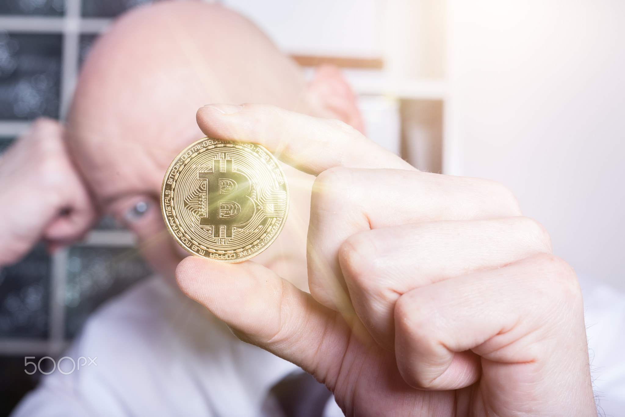 Businessman holding bitcoin and thinking