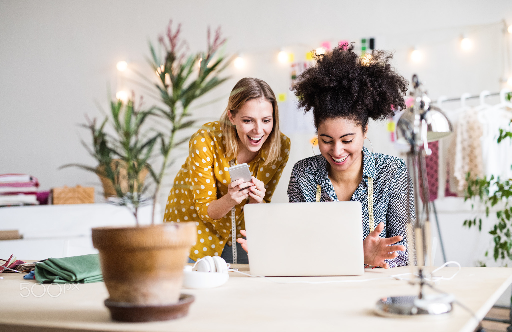 Young creative women with laptop in studio, startup business.